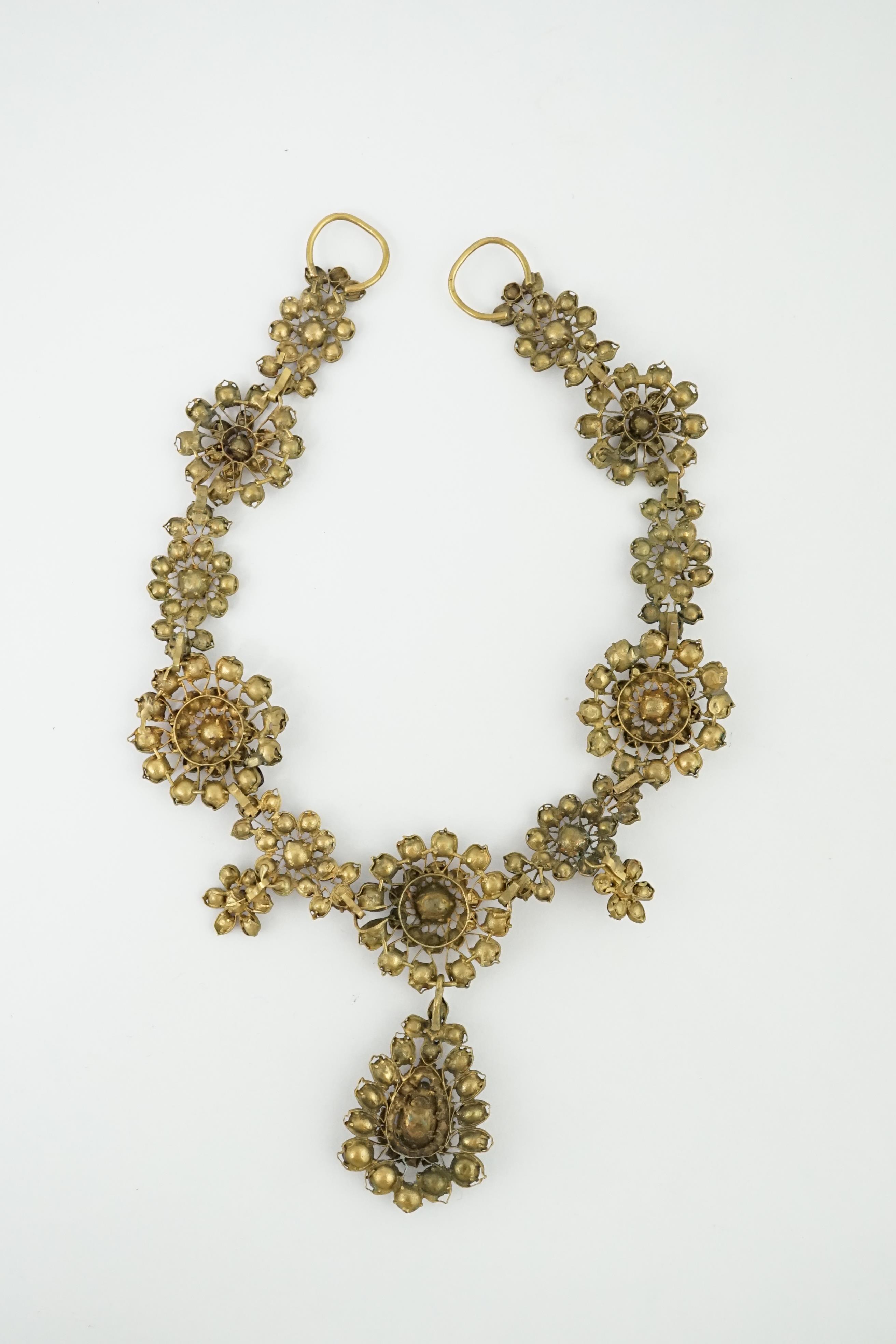 A good 18th century gilt metal and foil backed garnet cluster drop necklace, in original box